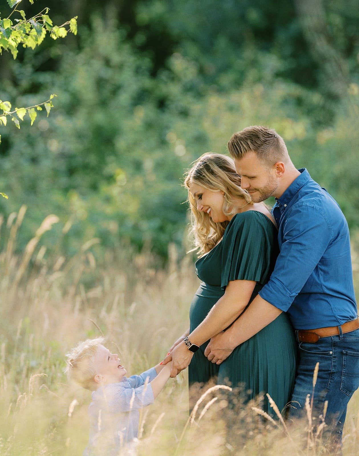 pregnant lady and family in beautiful woodland on a photoshoot
